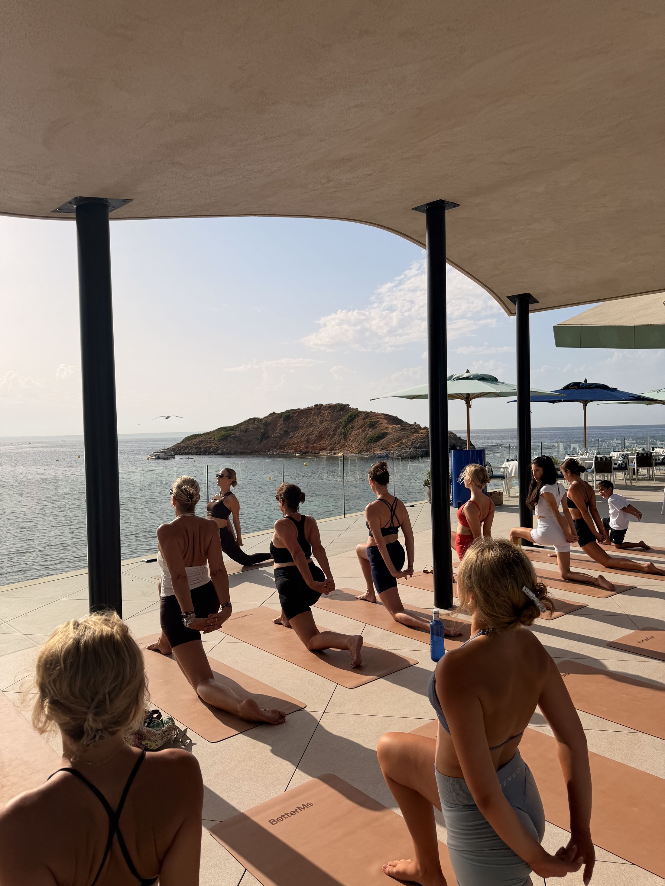 Yoga class on a seafront terrace overlooking the Mediterranean at Puerto Portals
